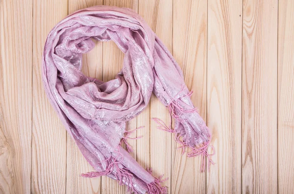 Pink scarf on a wooden background — Stock Photo, Image