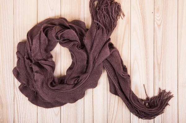 Brown scarf on wooden background — Stock Photo, Image