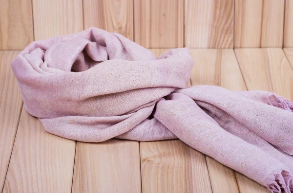 Pink scarf on a wooden background — Stock Photo, Image