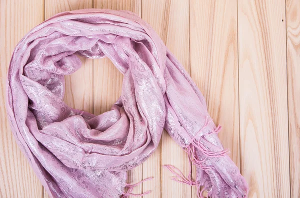 Pink scarf on a wooden background — Stock Photo, Image