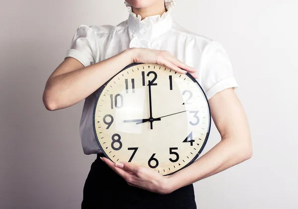 Business woman holding a clock — Stock Photo, Image