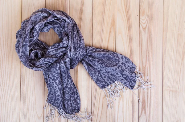 Gray scarf on wooden background — Stock Photo, Image