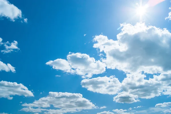 Beautiful blue sky with clouds and sun — Stock Photo, Image