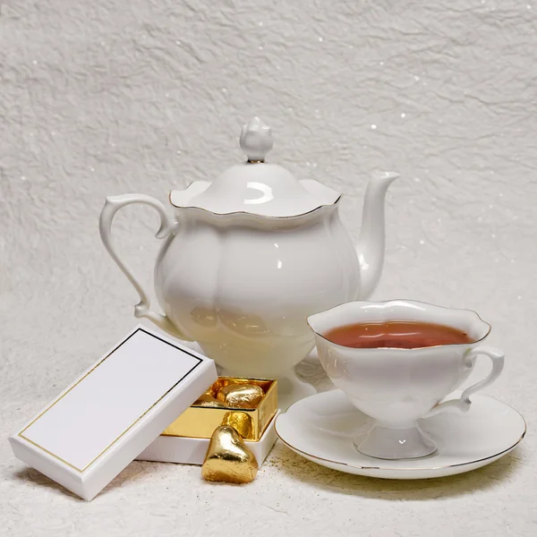 Tea set with box of gold candies — Stock Photo, Image