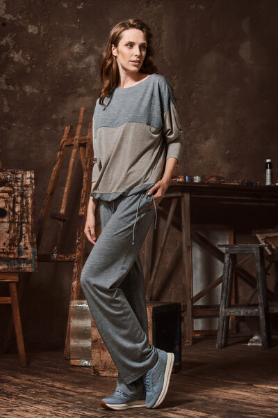 Young woman poses in studio of the artist