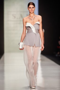 A model walks on the Maison SAS catwalk