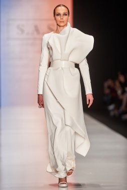 A model walks on the Maison SAS catwalk