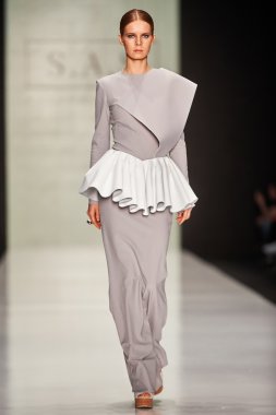 A model walks on the Maison SAS catwalk