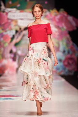 A model walks on the OKSANA FEDOROVA catwalk