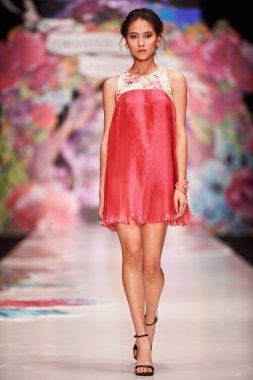 A model walks on the OKSANA FEDOROVA catwalk