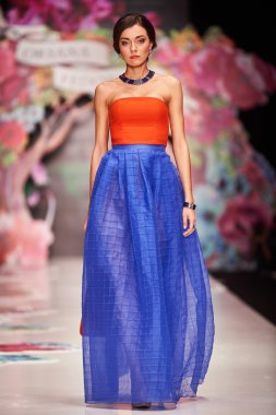 A model walks on the OKSANA FEDOROVA catwalk