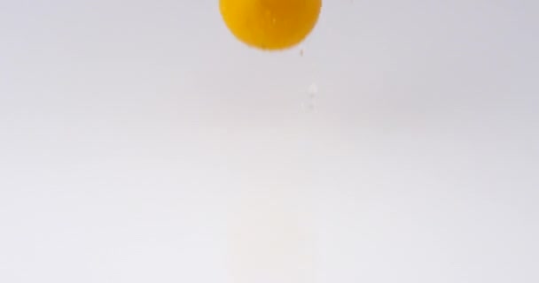 Slow Motion Juicy Oranges Dropping Bouncing Water White Reflective Surface — Stock Video