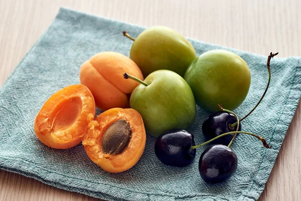 Cherries, green plums and apricots — Stock Photo, Image