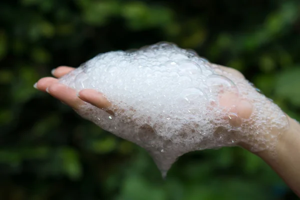 Bubbles in the hands of women — Stock Photo, Image