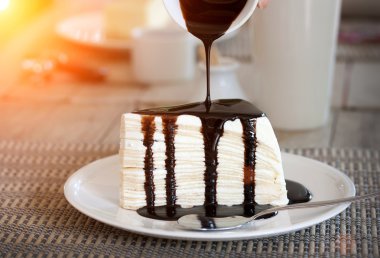 Pour chocolate sauce into cheesecake clipart