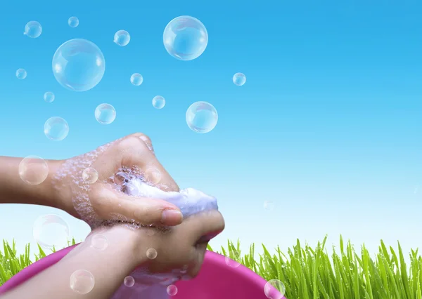 Female Hand washing clothes in the pink basin with clear Bubble — Stock Photo, Image