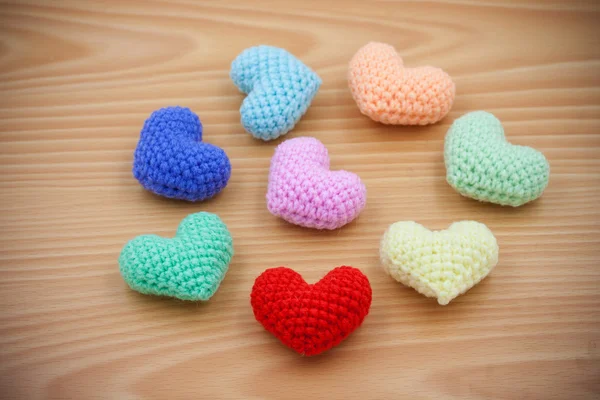 Colorful Yarn hearts on wood background — Stock Photo, Image