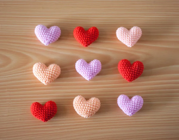 Colorful Yarn hearts on wood background — Stock Photo, Image