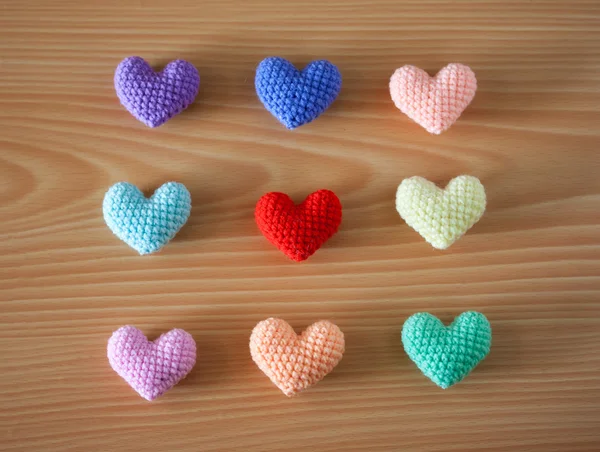 Colorful Yarn hearts on wood background — Stock Photo, Image