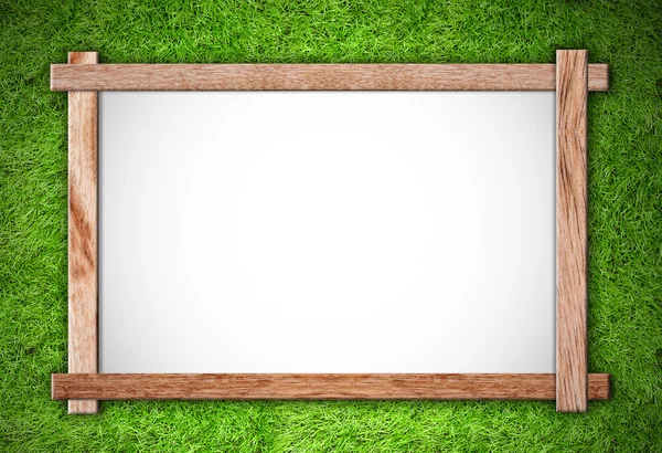 Houten frame op groen gras achtergrond — Stockfoto