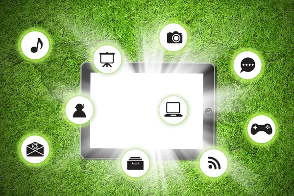 Tablet pc on with icon on grass background