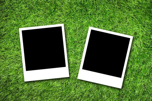 Photo frame on grass — Stock Photo, Image