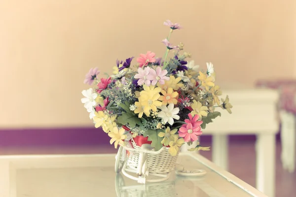 Flowers in white basket on table — Stock Photo, Image