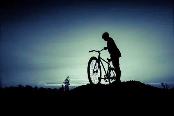 儿童和自行车在日落时的剪影 — 图库照片