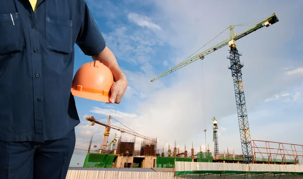 Engineer holding orange helmet for workers security — Stock Photo, Image