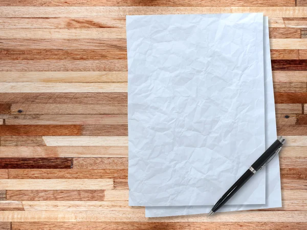 Белый лист бумаги на деревянном столе — стоковое фото