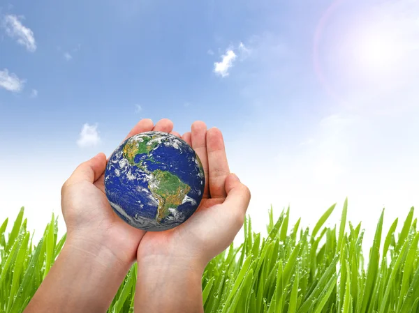 Earth planet in female hand and blue sky — Stock Photo, Image