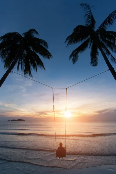 Woman relaxing on a swing with sunlight. — Stock Photo, Image