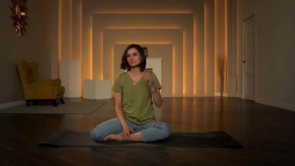 Slender girl doing exercises while sitting — Stockvideo