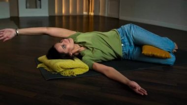 Slender girl doing exercises lying on her back