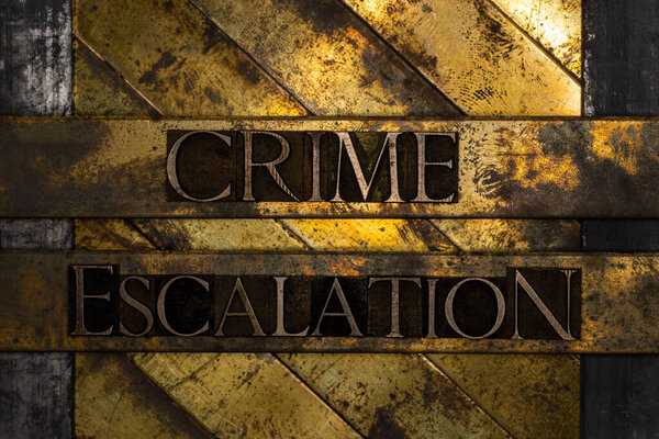Crime Escalation text formed by real authentic typeset letters on vintage textured grunge bronze background