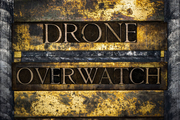 Drone Overwatch text on textured grunge copper and vintage gold background