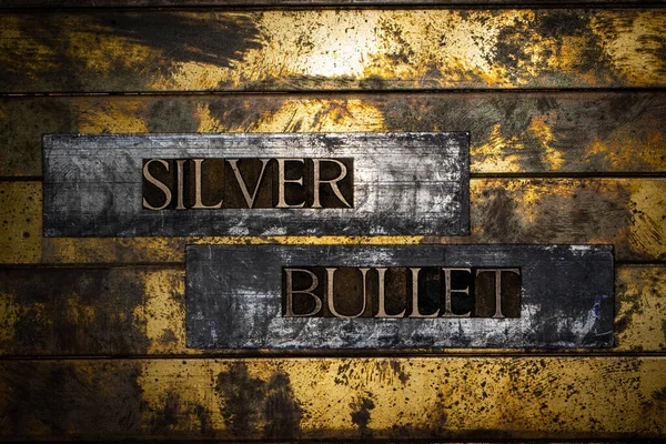 Silver Bullet text on vintage textured silver grunge copper and gold background