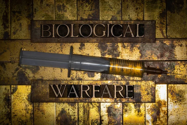 Biological Warfare text with fluid filled syringe on grunge textured copper and gold background