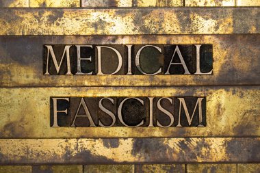Medical Fascism text on vintage textured grunge copper and gold steampunk background clipart