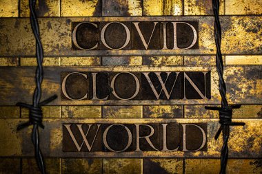 Covid Clown World text on vintage textured grunge copper and gold background clipart