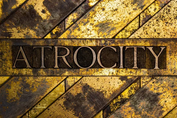 Atrocity Text Textured Grunge Copper Vintage Gold Background — Stock Photo, Image