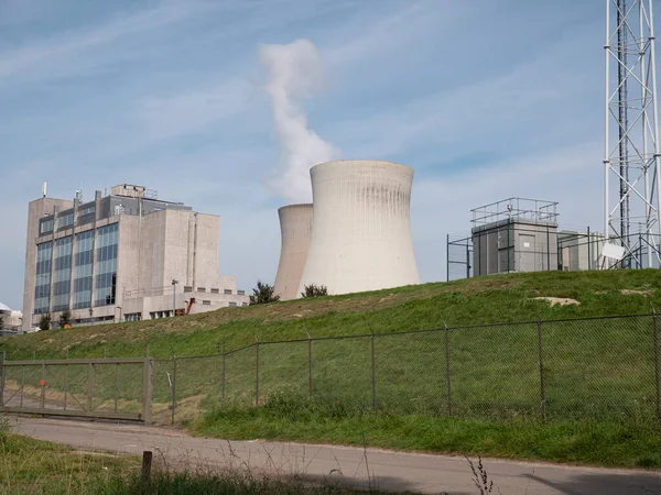 The nuclear power station of Doel in Belgium, with a blue sky and white steam