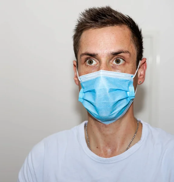young adult with a medical face mask on white background