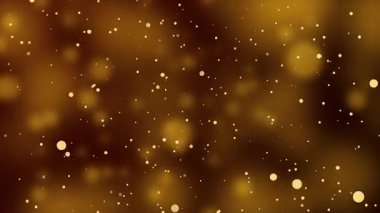 Parlayan altın parçacıklar yavaşça karanlık soyut sinematik arkaplanda sürükleniyorlar.