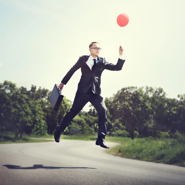 Empresário alegre com balão — Fotografia de Stock