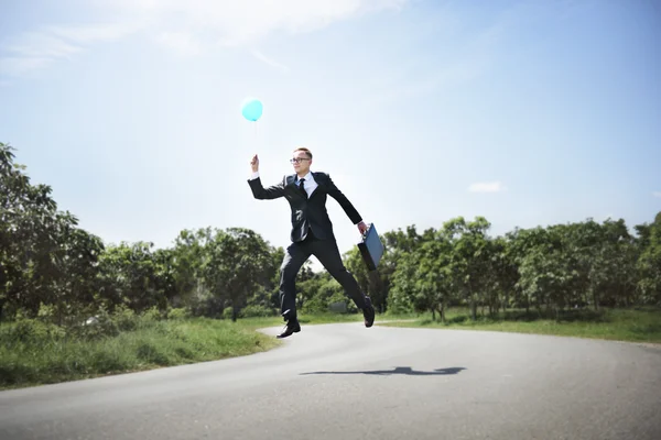 Empresário alegre com balão — Fotografia de Stock