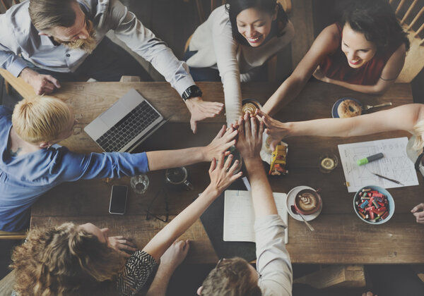 People making pile of hands