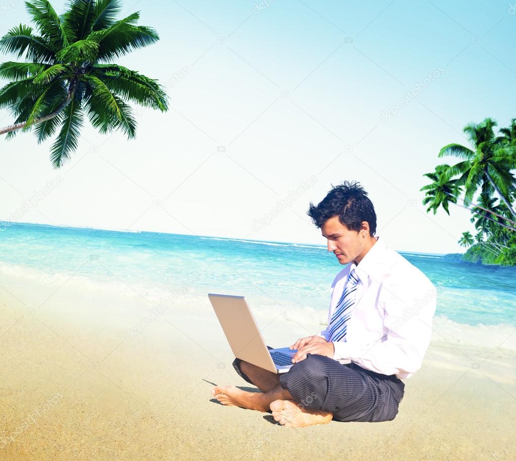 Businessman working on beach