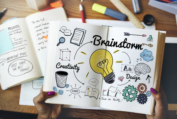 Woman holding book with brainstorm — Stock Photo, Image