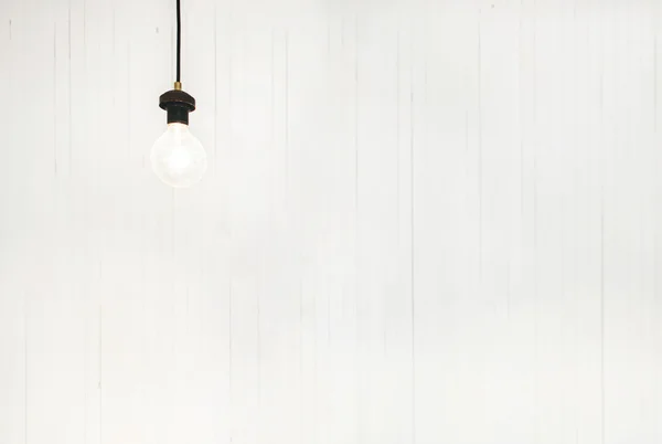 Light Bulb on White Wall — Stock Photo, Image